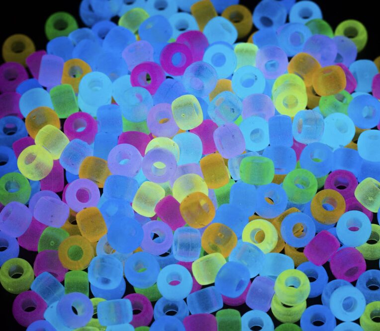 Glow-in-the-dark pony beads glowing in bright colors
